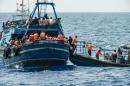 This handout picture released by MSF on August 27, 2015 shows migrants on a wooden boat during a rescue operation by MSF and the Swedish coast guard in the Meditterranean sea on August 26, 2015