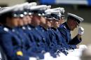 A graduating Air Force Academy cadet straightens his cap during the graduation ceremony for the class of 2015, at the U.S. Air Force Academy, in Colorado Springs, Colo., Thursday, May 28, 2015. (AP Photo/Brennan Linsley)