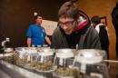 Tyler Williams of Blanchester, Ohio selects marijuana strains to purchase at the 3-D Denver Discrete Dispensary on January 1, 2014 in Denver, Colorado