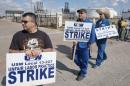 Workers from the USW union walk a picket line outside the Lyondell-Basell refinery in Houston, Texas.