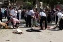 Forensic workers and policemen carry out investigations at the scene of a bomb blast in Cairo