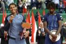 Spain's Rafael Nadal holds his cup after defeating France's Gael Monfils, right, in the final match of the Monte Carlo Tennis Masters tournament in Monaco, Sunday, April 17, 2016. (AP Photo/Lionel Cironneau)