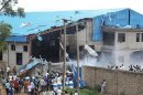 Onlookers gather near the bomb-damaged Shalom Church in the northern Nigerian city of Kaduna