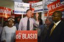 New York mayoral candidate Blasio, standing between his daughter Chiara and district attorney candidate Thompson, speaks during a campaign rally in Brooklyn, New York