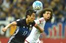 United Arab Emirates' Omar Abdulrahman (right) battles for the ball with Japan's Makoto Hasebe in their World Cup qualifier in Saitama on September 1, 2016