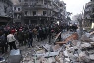 Civilians and Free Syrian Army fighters gather at the site hit by a missile in Aleppo's al-Mashhad district January 7, 2013. REUTERS/Muzaffar Salman