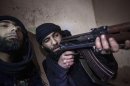 In this Wednesday, Dec. 5, 2012 photo, a Free Syrian Army fighter aims his weapon during heavy clashes with government forces in Aleppo, Syria. (AP Photo/Narciso Contreras)