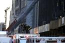 A New York City firefighter works on the scene where a building undergoing demolition work partially collapsed, in New York