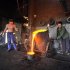 Labourers pour molten iron into a container at a foundry in Xiangfan