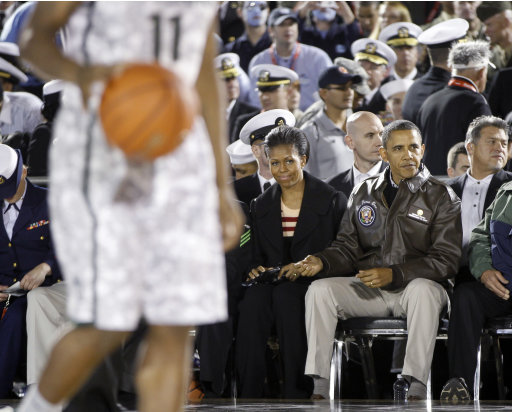 President Barack Obama and first lady Michelle Obama watch the Carrier Classic NCAA college basketball game between North Carolina and Michigan State on the flight deck of the USS Carl Vinson in Coronado, Calif., Friday, Nov. 11, 2011. (AP Photo/Susan Walsh)
