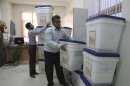 Officials prepare ballot boxes for Friday's presidential and city council elections in the northern Iranian city of Amol