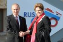 Vladimir Putin (left) welcomes Dilma Rousseff at the start of the G20 summit in Saint Petersburg, on September 5, 2013