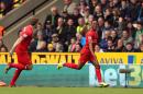 Liverpool's Raheem Sterling, right, celebrates scoring the opening goal during their English Premier League match against Norwich City at Carrow Road, Norwich, eastern England, Sunday April 20, 2014. (AP Photo/PA, Chris Radburn) UNITED KINGDOM OUT NO SALES NO ARCHIVE