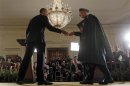 Obama and Karzai shake hands after a news conference in Washington