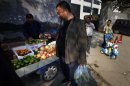 Dissident Chinese artist Ai Weiwei buys fruit on the street outside the Chaoyang District Court in Beijing