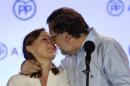 Spain's acting Primer Minister and candidate of Popular Party Mariano Rajoy, kisses his wife Elvira Fernandez as they celebrate the results of their party during the national elections in Madrid, Spain, Sunday, June 26, 2016. Spain's repeat election on Sunday failed to clarify the political future of the European Union's fifth-largest economy, with the main parties placing roughly the same as in last December's ballot, which brought six months of stalemate. (AP Photo/Daniel Ochoa de Olza)