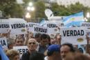 Protesters hold up signs that read "Truth" during a silent march to honour late state investigator Alberto Nisman in Buenos Aires
