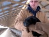 In this Feb. 12, 2013 photo Bob Zimbal holds one of his minks near rows of cages at his fur farm in Sheboygan Falls, Wis. Retail fur sales in the U.S. remain in a slump, but the demand for higher quality furs among the newly  wealthy in China has helped push pelt prices to record levels and shielded U.S. farmers like Zimbal from the sluggish economy. (AP Photo/Carrie Antlfinger)