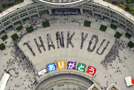 File photo of an aerial view shows people sitting in formation to the words &quot;thank you&quot; and displaying signs that collectively read &quot...