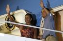 U.S. President Barack Obama and first lady Michelle Obama wave good bye before boarding Air Force One at Joint Base Hickam in Honolulu