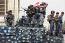Iraqi security forces stand guard during a protest on March 25, 2016, outside the main gates of Baghdad's Green Zone