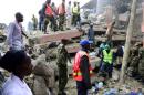 Rescue workers search for residents feared trapped in the rubble of a six-storey building that collapsed after days of heavy rain, in Nairobi