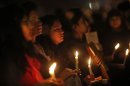 Indians hold a candle light vigil to salute the undying spirit of a rape victim and to mourn her death in New Delhi, India , Sunday, Dec. 30, 2012. The young woman who died after being gang-raped and beaten on a bus in India's capital was cremated Sunday amid an outpouring of anger and grief by millions across the country demanding greater protection for women from sexual violence. (AP Photo/ Saurabh Das)