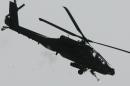 A US Apache gunship helicopter covering US soldiers during a clearing operation outside Baquba on October 8, 2007