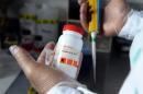 A scientist holds a flask containing the chemical Bisphenol-A on October 9, 2012 at a research institute in Toulouse, France