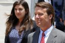 John Edwards, right, leaves a federal courthouse during the eighth day of jury deliberations with his daughter Cate, left, in his trial on charges of campaign corruption in Greensboro, N.C., Wednesday, May 30, 2012. The judge in John Edwards' campaign corruption trial says she has received a note from a juror on Wednesday. (AP Photo/Chuck Burton)