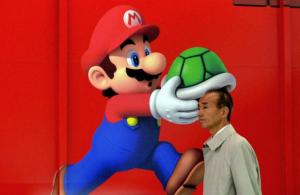 A man walks past an advertisement for Nintendo at an&nbsp;&hellip;