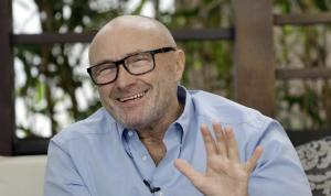 British musician Phil Collins, smiles as he talks to …