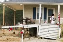 Holiday decorations are seen on the front porch of a damaged home on Bay Avenue in Mantoloking.