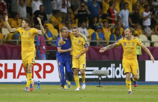 Ukraine's Shevchenko celebrates his second scoring with Selin, coach Blokhin and Voronin during their Group D Euro 2012 soccer match against Sweden at Olympic stadium in Kiev