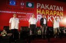 Chief minister of Malaysia's northern state of Penang Lim Guan Eng and other opposition leaders sing national anthem during the People's Alliance rally ahead of the elections outside Kuala Lumpur