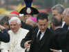 ** FILE ** In this Monday, April 21, 2008 file photo, Pope Benedict XVI, left, arrives at the Italian air force 31st Squadron base in Ciampino, 30 kilometers south-east of Rome, on his way back from a six-day trip to the U.S. including the U.N. and Ground Zero in N.Y.C.  The Vatican has confirmed Saturday, May 26, 2012, that the pope's butler Paolo Gabriele, at right carrying bags, was arrested in an embarrassing leaks scandal. Spokesman Rev. Federico Lombardi said Paolo Gabriele, a layman, was arrested in his home inside Vatican City with secret documents in his possession.  Vatican documents leaked to the press in recent months have pointed to power struggles and accusations of corruption touching senior Vatican cardinals.(AP Photo/Domenico Stinellis)