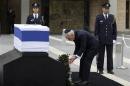 Israel's President Peres lays a wreath near the coffin of former Israeli prime minister Sharon at the Knesset in Jerusalem