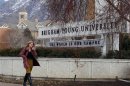 A student walks past the entrance of Brigham Young University in Provo