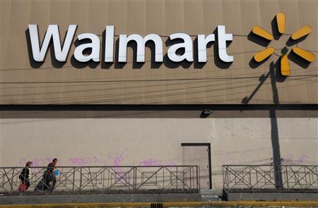 Two people walk outside a Wal-Mart store in Mexico City January 11, 2013. REUTERS/Edgard Garrido