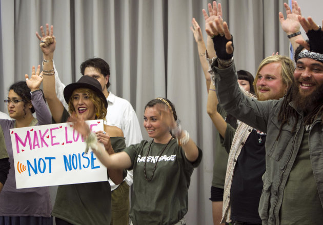 Environmentalists and supporters of Greenpeace hold their hands up to express their support for fellow speakers during a California Coastal Commission meeting in Santa Monica, Calif. Wednesday, Nov. 14, 2012. The California Coastal Commission is weighing whether to grant a permit to the Pacific Gas & Electric Co. to conduct seismic imaging off the coast of the Diablo Canyon nuclear plant. (AP Photo/Damian Dovarganes)