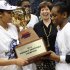 Notre Dame head coach Muffet McGraw, center smiles as Notre Dame's Skylar Diggins, left, and teammate Jewell Loyd hold the championship trophy after their 61-59 win over Connecticut in an NCAA college basketball game in the final of the Big East Conference women's tournament in Hartford, Conn., Tuesday, March 12, 2013. (AP Photo/Jessica Hill)
