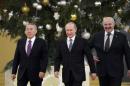 Russia's President Vladimir Putin (C), his Belarus counterpart Alexander Lukashenko (R) and Kazakh counterpart Nursultan Nazarbayev walk before a a meeting of the Supreme Eurasian Economic Council at the Kremlin in Moscow, December 24, 2013