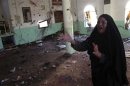 A woman reacts inside a Sunni mosque after two roadside bombs attacks on Sunni Muslim worshippers following Friday prayers in Baquba