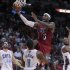 Heat's James drives against Bobcats' Mullens, Gordon and Walker in the second half of their NBA basketball game in Miami