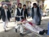 Afghans carry the body of a suicide attack victim at the hospital in Maymana, Faryab province, north west of Kabul, Afghanistan, Friday, Oct. 26, 2012.  A suicide bomber blew himself up outside a mosque in northern Afghanistan on Friday, killing dozens of people and wounding scores, government and hospital officials said. (AP Photo/Qawtbuddin Khan)