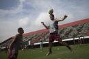 America's soccer player Russo heads the ball as teammate Marlon watches during practice at the America Football club on the outskirts of Rio de Janeiro, Brazil, Friday, May 29, 2015. "The majority of soccer clubs in Brazil have big problems," said fellow player Braz. "Players aren't paid, and then you see how the CBF benefits with so much money and luxury," referring to the Brazilian Football Confederation. (AP Photo/Felipe Dana)