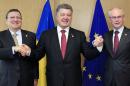 Ukraine's President Petro Poroshenko, center, poses with European Commission President Jose Manuel Barroso, left, and European Council President Herman Van Rompuy, right, during an EU Summit in Brussels on Friday, June 27, 2014. Ukrainian President Petro Poroshenko has signed up to a trade and economic pact with the European Union, saying it may be the "most important day" for his country since it became independent from the Soviet Union. (AP Photo)