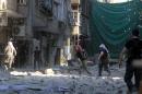 Rebel fighters take position on a front line in the Yarmuk refugee camp in Damascus on September 11, 2013