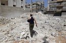 A wounded Free Syrian Army commander walks through rubble in the Salaheddine neighbourhood of central Aleppo