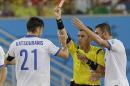 Referee Joel Aguilar from El Salvador shows a red card to Greece's Kostas Katsouranis, left, during the group C World Cup soccer match between Japan and Greece at the Arena das Dunas in Natal, Brazil, Thursday, June 19, 2014. (AP Photo/Ricardo Mazalan)